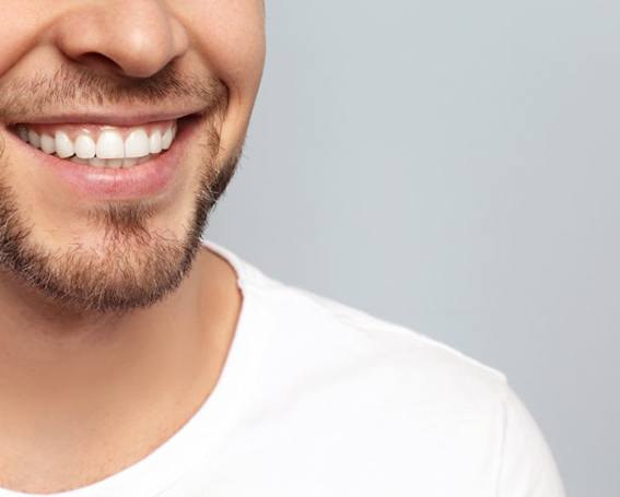 a man smiling with a full bite