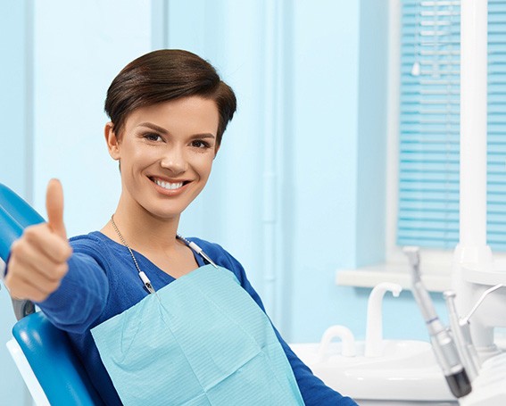 Happy female patient making thumbs up gesture
