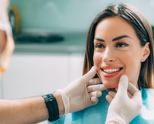 patient smiling while visiting dentist 