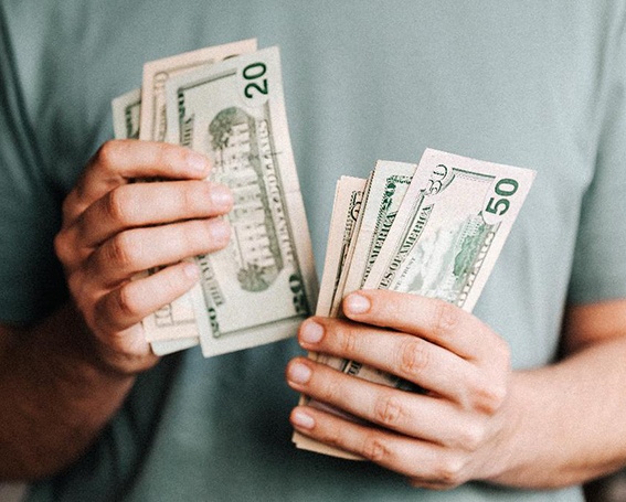 Close up of man’s hands counting cash