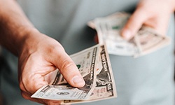 Close up of man extending cash for payment