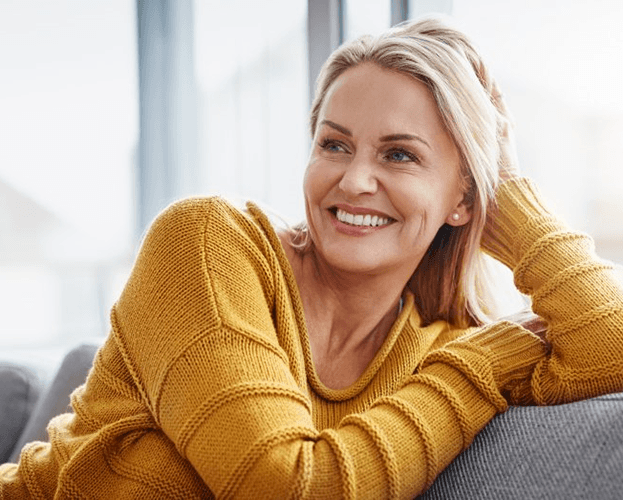 a woman in Leesburg smiling with her new dentures