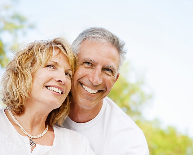 Senior couple outside smiling with dentures in Leesburg, VA