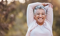 Senior woman outside stretching