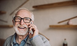 Senior man laughing and talking on his cell phone