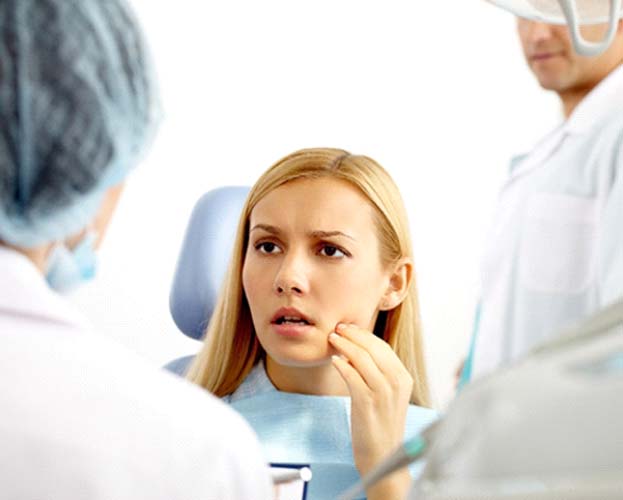 Woman listening to emergency dentist in Leesburg