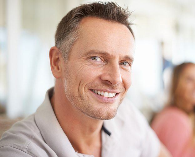 Man with healthy smile after tooth extraction