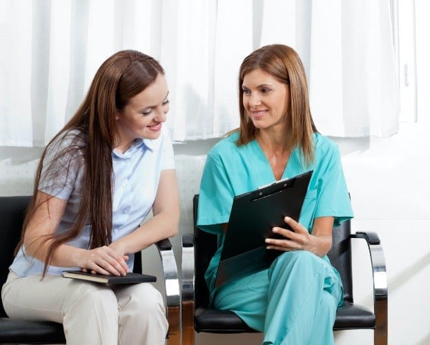 Dental patient and team member reviewing the cost of dental emergencies