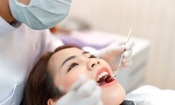 woman at dental checkup for cost of emergency dentistry in Leesburg