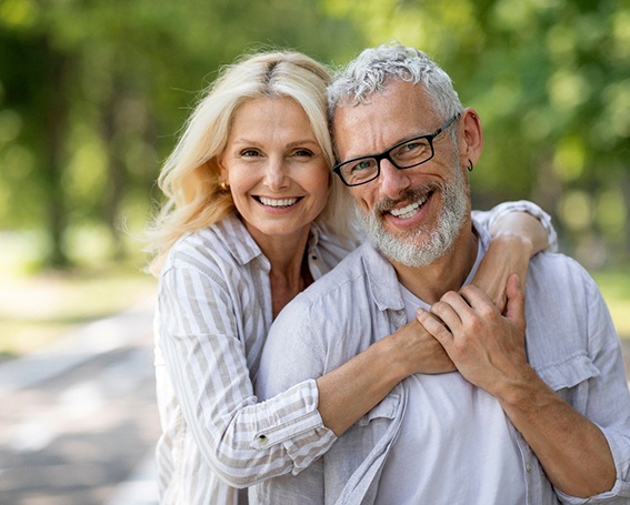 Portrait of happy senior couple standing outdoors