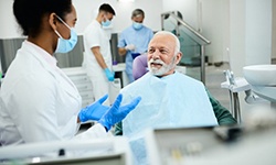 a patient talking to dentist after receiving dental implants
