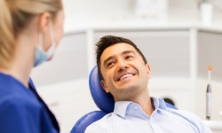 man smiling during his implant consultation
