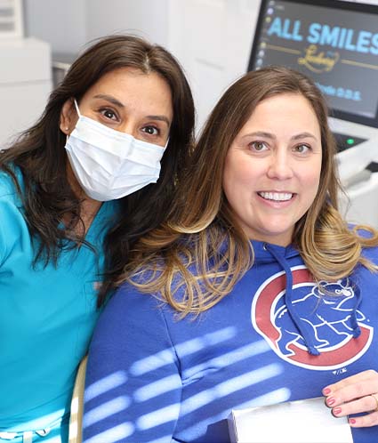 Dentist and patient smiling together