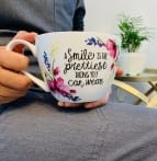 Coffee mug reading a smile is the prettiest thing you can wear