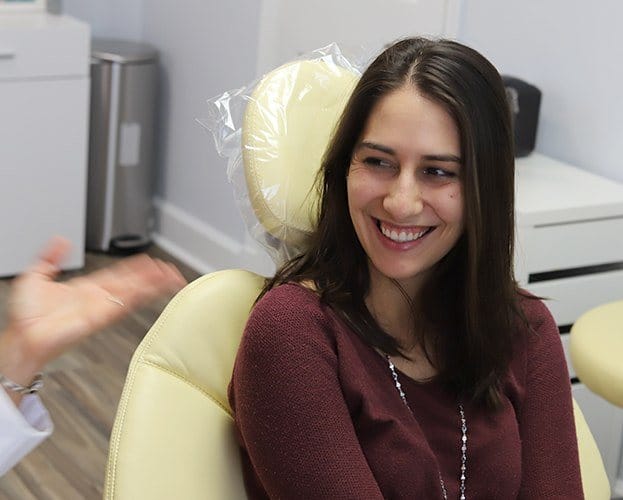 Woman in dental chair smiling