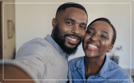 man and woman smiling together