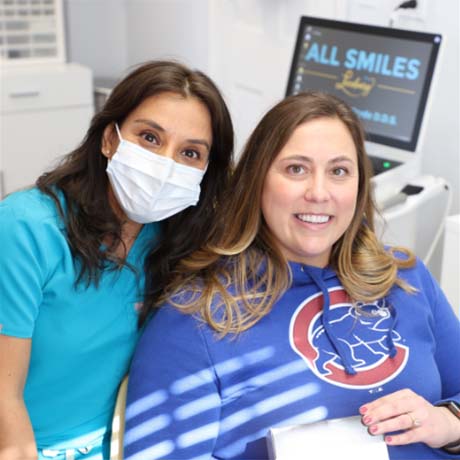 dental team member with smiling patient