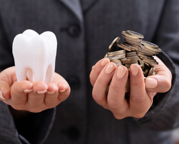 Hands balancing molar and coins