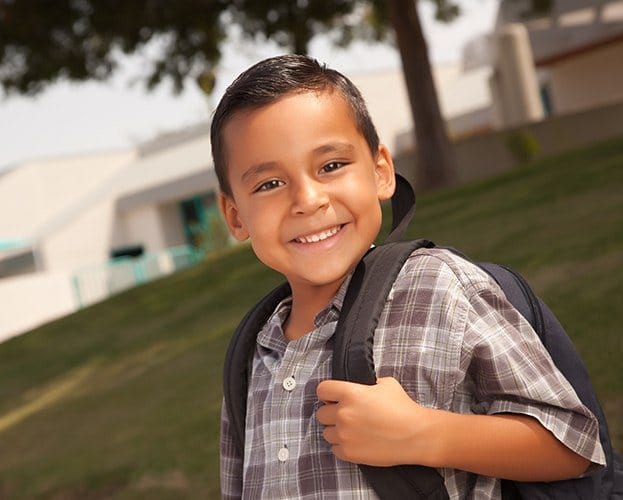 Child smiling after treatment for pediatric dental condition