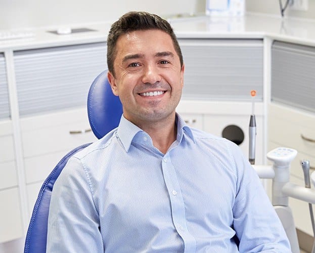 Man smiling during periodontal treatment