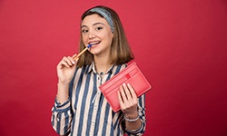 Woman chewing on a pen and smiling