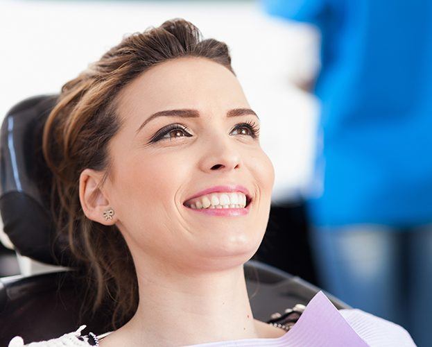 Woman smiling during preventive dentistry checkup and teeth cleaning visit