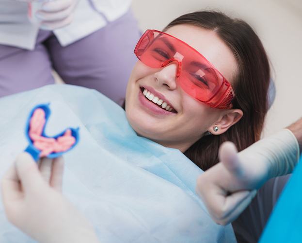 Smiling patient receiving fluoride treatments