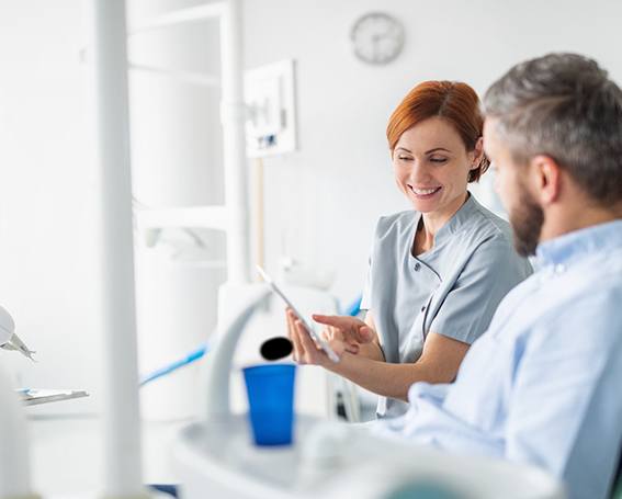 Patient and dental team member discussing treatment plan