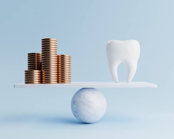 Tooth and money balanced on scale