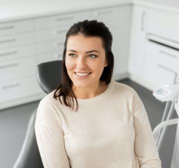 Woman in dental chair smiling during preventive dentistry visit