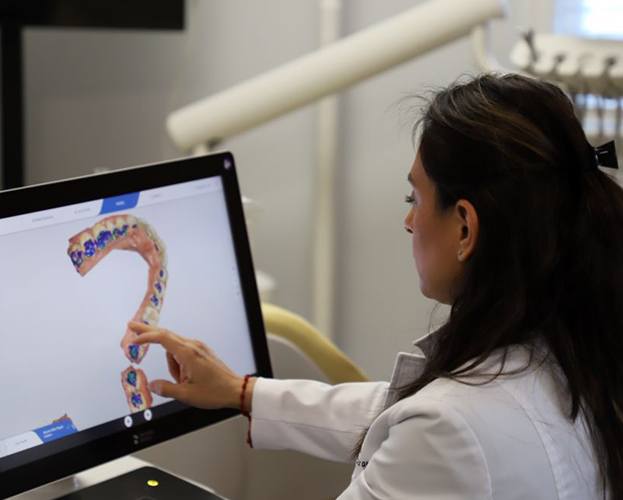 Dentist looking at digital impressions