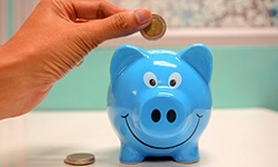 Blue piggy bank and coin
