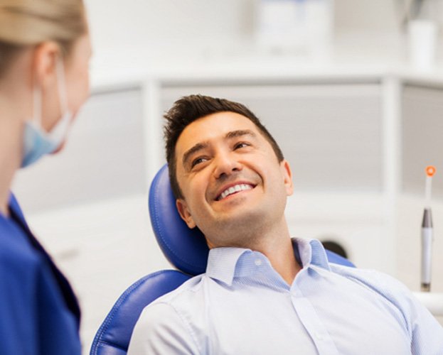 man talking with dentist for teeth whitening in Leesburg 