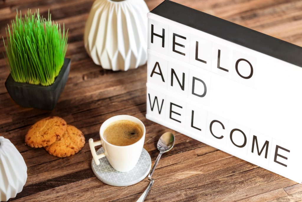 Hello and welcome letterboard next to tea on desk
