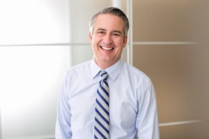 Smiling man wearing shirt and tie