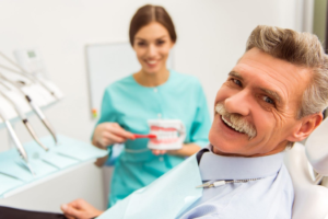 a person smiling before receiving dentures