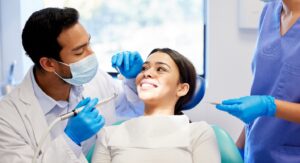 Dentist working with smiling patient.